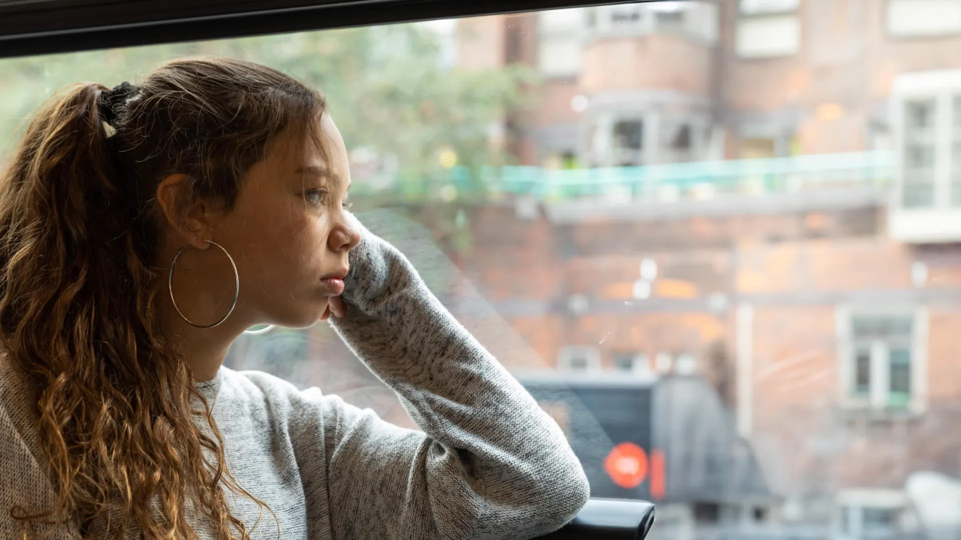 Female looking out the window